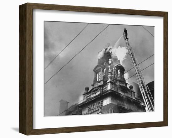 Fireman on Ladder Using a Hose to Extinguish Blazing Building Set Afire-Hans Wild-Framed Photographic Print