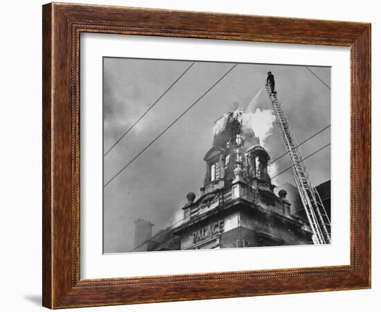 Fireman on Ladder Using a Hose to Extinguish Blazing Building Set Afire-Hans Wild-Framed Photographic Print