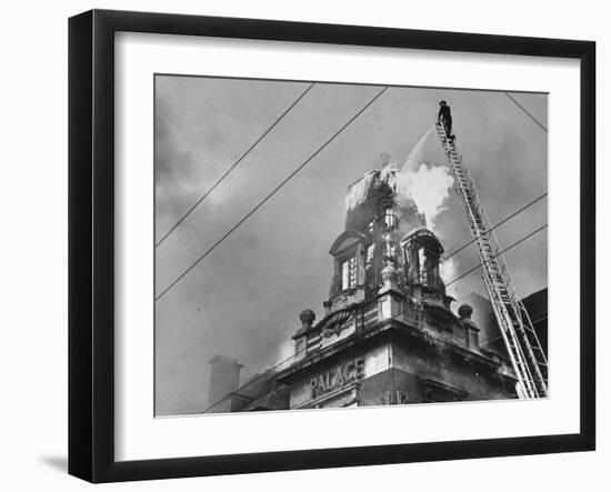 Fireman on Ladder Using a Hose to Extinguish Blazing Building Set Afire-Hans Wild-Framed Photographic Print