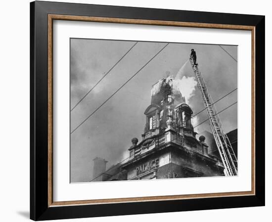 Fireman on Ladder Using a Hose to Extinguish Blazing Building Set Afire-Hans Wild-Framed Photographic Print