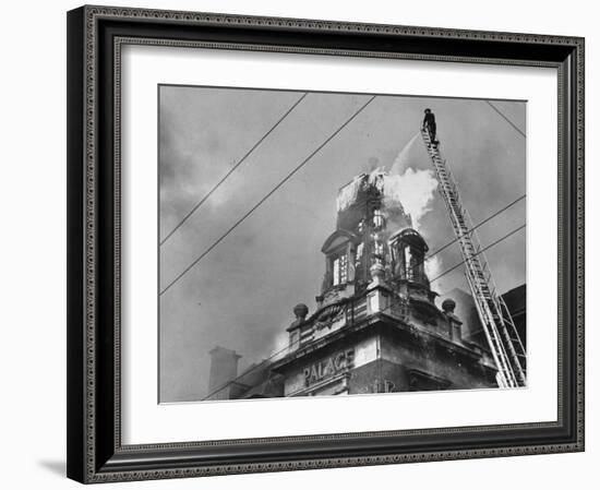 Fireman on Ladder Using a Hose to Extinguish Blazing Building Set Afire-Hans Wild-Framed Photographic Print