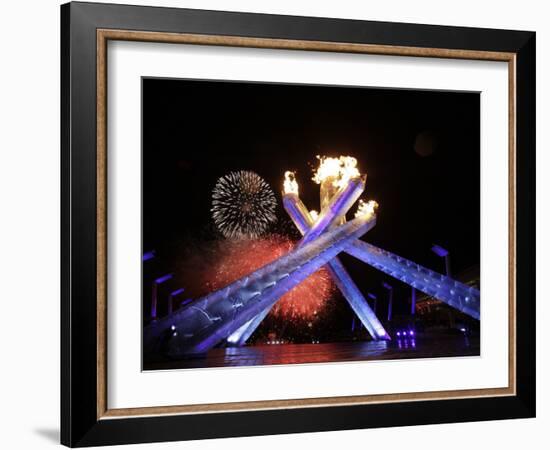 Fireworks Explode Behind the Olympic Flame at Opening Ceremony of Vancouver 2010 Winter Games-null-Framed Photographic Print