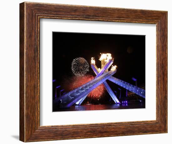 Fireworks Explode Behind the Olympic Flame at Opening Ceremony of Vancouver 2010 Winter Games-null-Framed Photographic Print