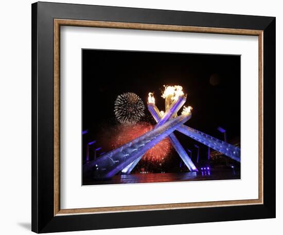 Fireworks Explode Behind the Olympic Flame at Opening Ceremony of Vancouver 2010 Winter Games-null-Framed Photographic Print