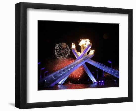 Fireworks Explode Behind the Olympic Flame at Opening Ceremony of Vancouver 2010 Winter Games-null-Framed Photographic Print