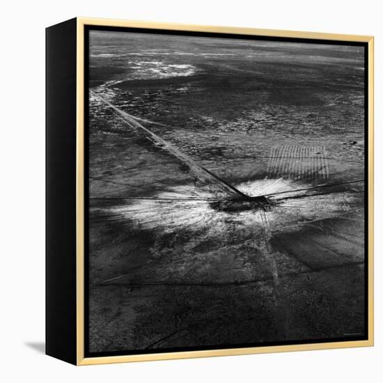 First Atomic Bomb's Dark Crater Surrounded by Glass Created by Heated Sand from Explosion-Fritz Goro-Framed Premier Image Canvas