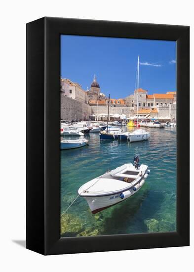 Fishing boat and clear water in the Old Port, Dubrovnik Old Town, Dubrovnik, Dalmatian Coast, Croat-Neale Clark-Framed Premier Image Canvas