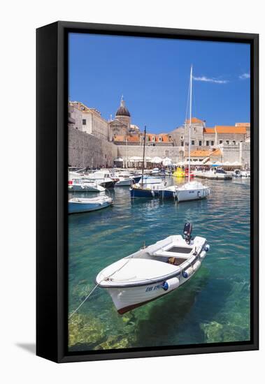 Fishing boat and clear water in the Old Port, Dubrovnik Old Town, Dubrovnik, Dalmatian Coast, Croat-Neale Clark-Framed Premier Image Canvas