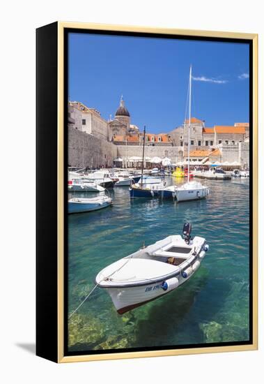 Fishing boat and clear water in the Old Port, Dubrovnik Old Town, Dubrovnik, Dalmatian Coast, Croat-Neale Clark-Framed Premier Image Canvas