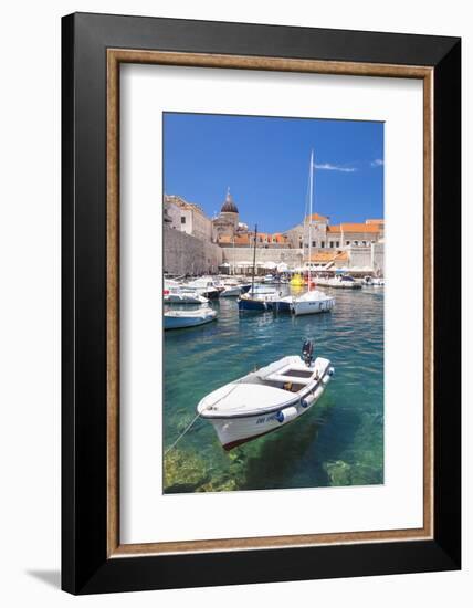 Fishing boat and clear water in the Old Port, Dubrovnik Old Town, Dubrovnik, Dalmatian Coast, Croat-Neale Clark-Framed Photographic Print