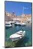 Fishing boat and clear water in the Old Port, Dubrovnik Old Town, Dubrovnik, Dalmatian Coast, Croat-Neale Clark-Mounted Photographic Print