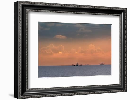 Fishing boats deep out to sea against the backdrop of dramatic sunset clouds and sky.-Sheila Haddad-Framed Photographic Print