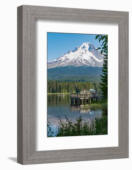 Fishing on Trillium Lake with Mount Hood, part of the Cascade Range, reflected in the still waters,-Martin Child-Framed Photographic Print