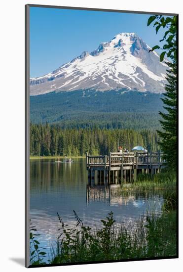 Fishing on Trillium Lake with Mount Hood, part of the Cascade Range, reflected in the still waters,-Martin Child-Mounted Photographic Print