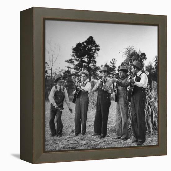 Five Male Musicians Dressed in Hats and Bib Overalls Standing in a Field-Eric Schaal-Framed Premier Image Canvas