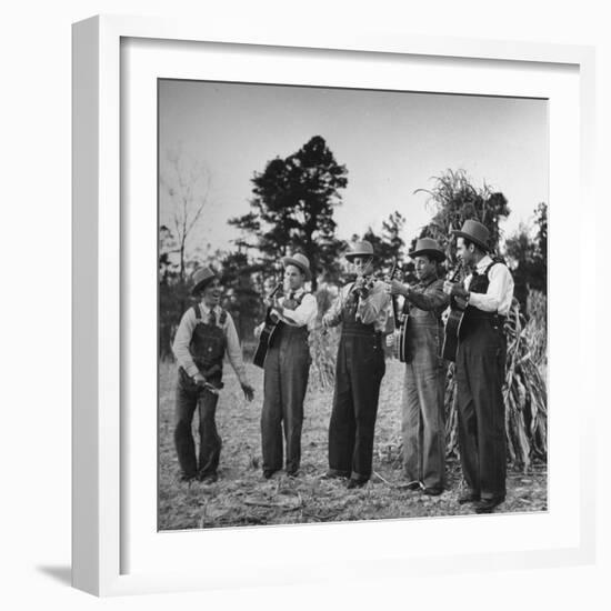 Five Male Musicians Dressed in Hats and Bib Overalls Standing in a Field-Eric Schaal-Framed Photographic Print