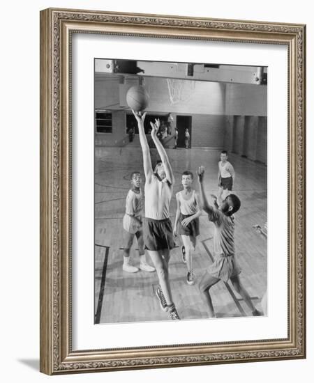 Five Young Boys Wearing Gym Clothes and Playing a Game of Basketball in the School Gym-null-Framed Photographic Print