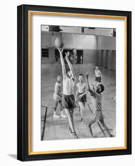 Five Young Boys Wearing Gym Clothes and Playing a Game of Basketball in the School Gym-null-Framed Photographic Print