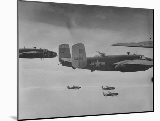 Flight of American B-25 Mitchell Bombers Enroute to a Bombing Mission over the Port of Madang-Myron Davis-Mounted Photographic Print