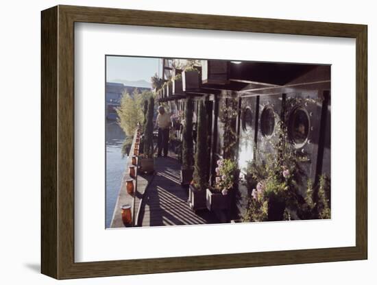 Floating-Home Owner Warren Owen Fonslor Waters the Plants on His Deck, Sausalito, CA, 1971-Michael Rougier-Framed Photographic Print