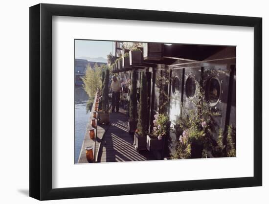 Floating-Home Owner Warren Owen Fonslor Waters the Plants on His Deck, Sausalito, CA, 1971-Michael Rougier-Framed Photographic Print