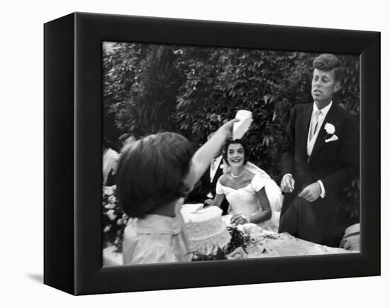 Flower Girl Janet Auchincloss Holding Up a Wedge of Wedding Cake for Bridegroom Sen. John Kennedy-Lisa Larsen-Framed Premier Image Canvas