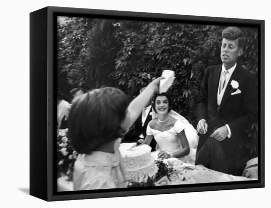 Flower Girl Janet Auchincloss Holding Up a Wedge of Wedding Cake for Bridegroom Sen. John Kennedy-Lisa Larsen-Framed Premier Image Canvas