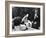 Flower Girl Janet Auchincloss Holding Up a Wedge of Wedding Cake for Bridegroom Sen. John Kennedy-Lisa Larsen-Framed Photographic Print