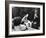 Flower Girl Janet Auchincloss Holding Up a Wedge of Wedding Cake for Bridegroom Sen. John Kennedy-Lisa Larsen-Framed Photographic Print