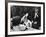 Flower Girl Janet Auchincloss Holding Up a Wedge of Wedding Cake for Bridegroom Sen. John Kennedy-Lisa Larsen-Framed Photographic Print