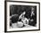 Flower Girl Janet Auchincloss Holding Up a Wedge of Wedding Cake for Bridegroom Sen. John Kennedy-Lisa Larsen-Framed Photographic Print