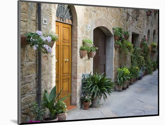 Flower Pots and Potted Plants Decorate a Narrow Street in Tuscan Village, Pienza, Italy-Dennis Flaherty-Mounted Photographic Print