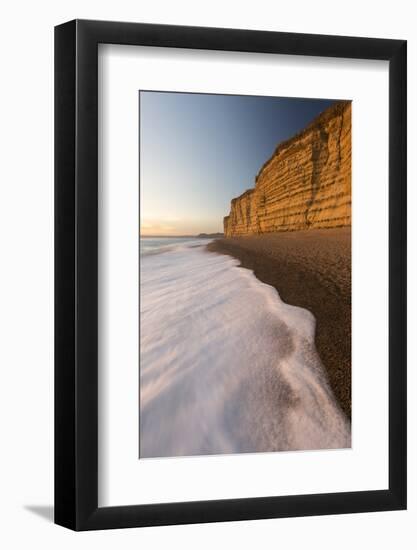 Foam on beach below cliffs at Burton Bradstock, Dorset, UK-Ross Hoddinott-Framed Photographic Print