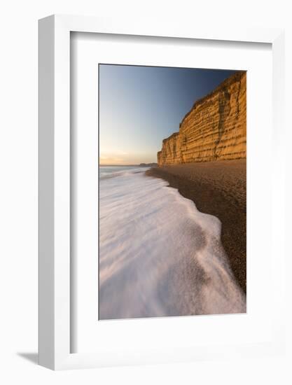 Foam on beach below cliffs at Burton Bradstock, Dorset, UK-Ross Hoddinott-Framed Photographic Print