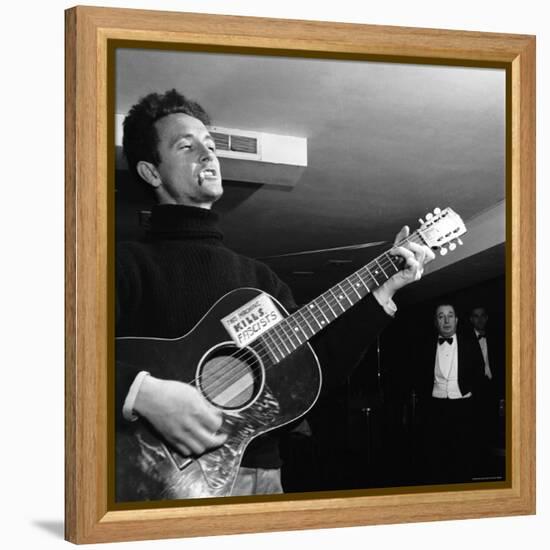 Folk Singer Woody Guthie Performing with Guitar Emblazoned with "This Machine Kills Fascists"-Eric Schaal-Framed Premier Image Canvas