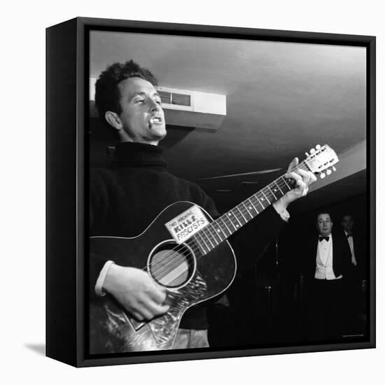 Folk Singer Woody Guthie Performing with Guitar Emblazoned with "This Machine Kills Fascists"-Eric Schaal-Framed Premier Image Canvas