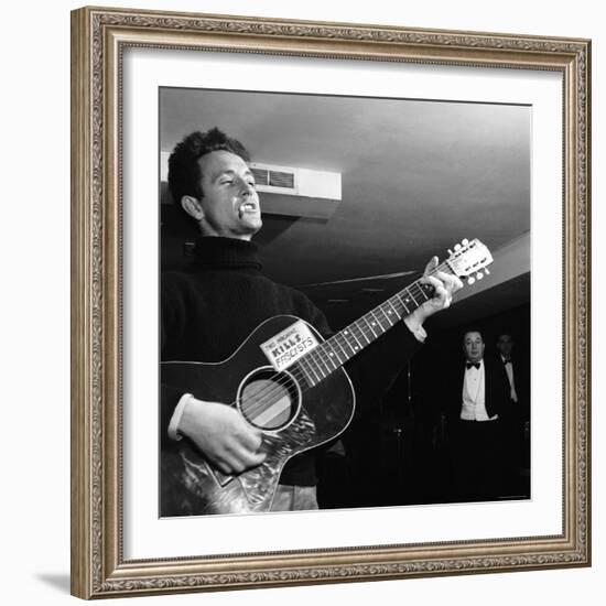 Folk Singer Woody Guthie Performing with Guitar Emblazoned with "This Machine Kills Fascists"-Eric Schaal-Framed Premium Photographic Print