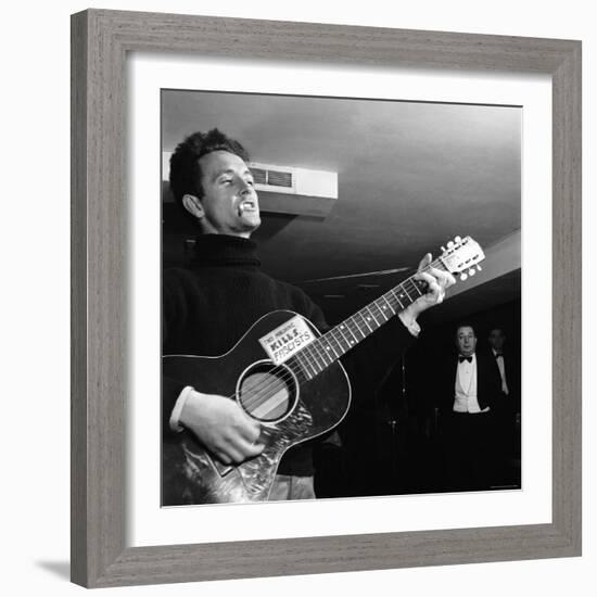 Folk Singer Woody Guthie Performing with Guitar Emblazoned with "This Machine Kills Fascists"-Eric Schaal-Framed Premium Photographic Print