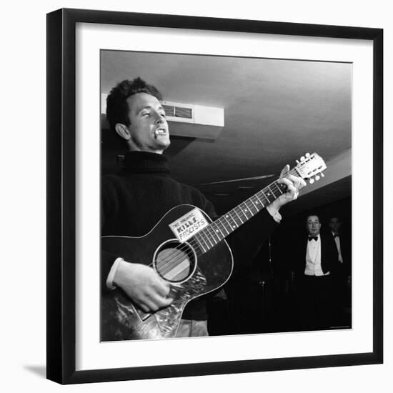 Folk Singer Woody Guthie Performing with Guitar Emblazoned with "This Machine Kills Fascists"-Eric Schaal-Framed Premium Photographic Print