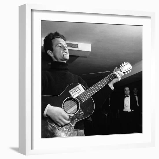 Folk Singer Woody Guthie Performing with Guitar Emblazoned with "This Machine Kills Fascists"-Eric Schaal-Framed Premium Photographic Print