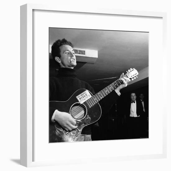 Folk Singer Woody Guthie Performing with Guitar Emblazoned with "This Machine Kills Fascists"-Eric Schaal-Framed Premium Photographic Print