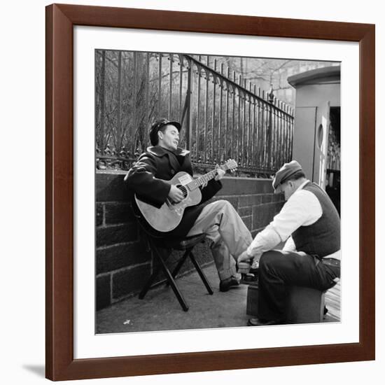 Folk Singer Woody Guthrie Palying His Guitar While Getting a Shoeshine-null-Framed Premium Photographic Print