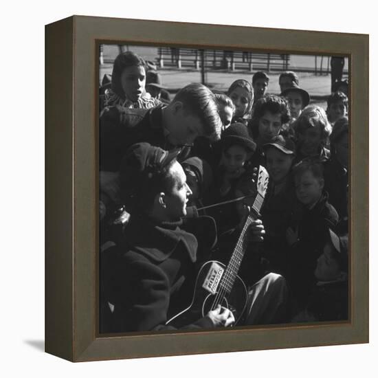 Folk Singer Woody Guthrie Playing Guitar for Group of Children-Eric Schaal-Framed Premier Image Canvas