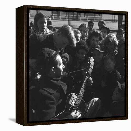 Folk Singer Woody Guthrie Playing Guitar for Group of Children-Eric Schaal-Framed Premier Image Canvas