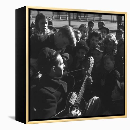 Folk Singer Woody Guthrie Playing Guitar for Group of Children-Eric Schaal-Framed Premier Image Canvas