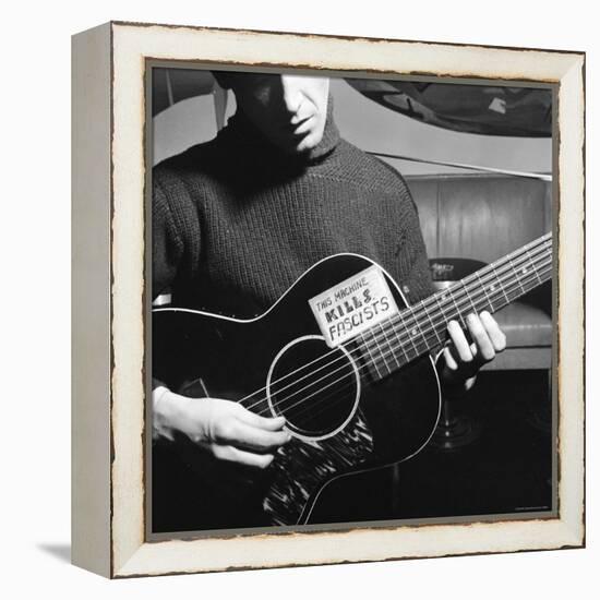 Folk Singer Woody Guthrie Playing Guitar with Sign on It Reading This Machine Kills Fascists-Eric Schaal-Framed Premier Image Canvas