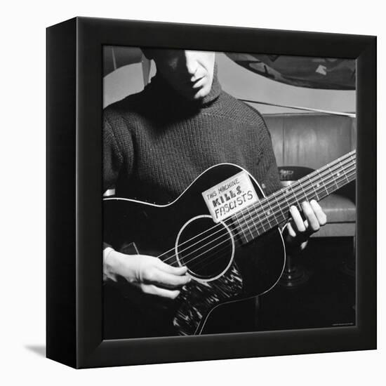 Folk Singer Woody Guthrie Playing Guitar with Sign on It Reading This Machine Kills Fascists-Eric Schaal-Framed Premier Image Canvas