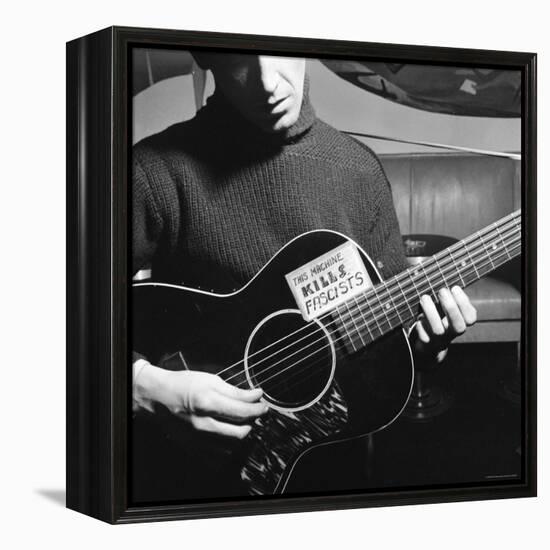 Folk Singer Woody Guthrie Playing Guitar with Sign on It Reading This Machine Kills Fascists-Eric Schaal-Framed Premier Image Canvas