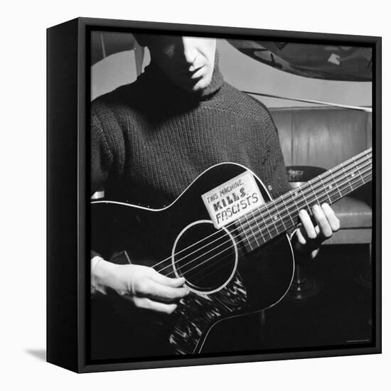 Folk Singer Woody Guthrie Playing Guitar with Sign on It Reading This Machine Kills Fascists-Eric Schaal-Framed Premier Image Canvas