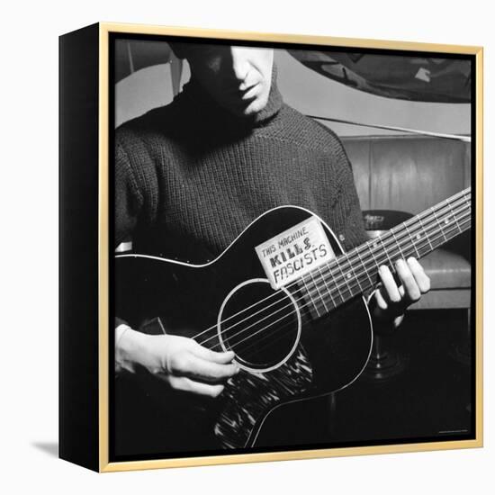 Folk Singer Woody Guthrie Playing Guitar with Sign on It Reading This Machine Kills Fascists-Eric Schaal-Framed Premier Image Canvas